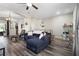 Inviting living room featuring sleek flooring, a plush sectional sofa, and an open layout at 213 Strathmore Cir, Kissimmee, FL 34744
