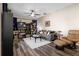 Comfortable living room featuring a ceiling fan, modern gray sofa, and dark wood-look floors at 213 Strathmore Cir, Kissimmee, FL 34744
