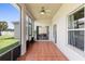 Screened-in patio with tile flooring, ceiling fan, and view of the backyard at 213 Strathmore Cir, Kissimmee, FL 34744