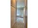 Bathroom with marble floors and a soaking tub, walk-in shower with glass door, and closet space at 2320 Andrews Valley Dr, Kissimmee, FL 34758