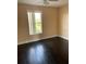 Bright bedroom featuring a ceiling fan, hardwood floors and a window bringing in natural light at 2320 Andrews Valley Dr, Kissimmee, FL 34758