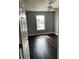 This bedroom has hardwood floors, a ceiling fan and a window that overlooks a green landscape at 2320 Andrews Valley Dr, Kissimmee, FL 34758