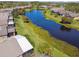 An aerial shot showcases the picturesque community with a serene lake winding through well-manicured lawns at 238 Acadia Dr, Poinciana, FL 34759