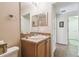 Bathroom with sink and mirror and door to another room at 238 Acadia Dr, Poinciana, FL 34759