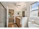 En suite bathroom includes a double sink vanity, a walk-in shower with glass door, and an enclosed toilet area at 238 Acadia Dr, Poinciana, FL 34759