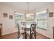 Charming breakfast nook with a round glass table, seating for four, and three large windows offering bright natural light at 238 Acadia Dr, Poinciana, FL 34759