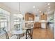 Breakfast nook with glass table and wood chairs with lots of natural light at 238 Acadia Dr, Poinciana, FL 34759