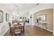 The dining area showcases tile flooring, a stylish light fixture, and views into the living room at 238 Acadia Dr, Poinciana, FL 34759
