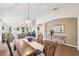 Open-concept dining area with views to the living room, neutral paint and updated lighting at 238 Acadia Dr, Poinciana, FL 34759