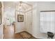 Light and airy entryway with tile flooring, front door, and sidelight window at 238 Acadia Dr, Poinciana, FL 34759