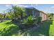 Enjoy the shade of the palm trees next to the screened-in patio at 238 Acadia Dr, Poinciana, FL 34759
