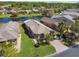 Charming home featuring lush landscaping, a brick paver driveway, and an attached two-car garage at 238 Acadia Dr, Poinciana, FL 34759