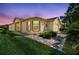 A quaint home featuring brick paver walkway, large windows, shutters and beautiful landscaping at 238 Acadia Dr, Poinciana, FL 34759