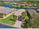 A charming home featuring lush landscaping, a brick paver driveway, and an attached two-car garage at 238 Acadia Dr, Poinciana, FL 34759
