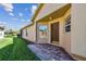 Neutral colored home featuring brick paver walkway, manicured landscaping, and a beautiful front door at 238 Acadia Dr, Poinciana, FL 34759