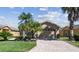 Home with beautiful lawn, landscaping, brick paver driveway and two-car garage at 238 Acadia Dr, Poinciana, FL 34759