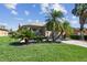 Well-manicured front lawn with lovely landscaping, a brick paver driveway and neutral colored exterior at 238 Acadia Dr, Poinciana, FL 34759