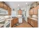 Efficient kitchen with wooden cabinets, white appliances, and tile floors at 238 Acadia Dr, Poinciana, FL 34759