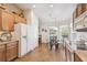 Kitchen features wooden cabinets, white refrigerator and attached breakfast nook at 238 Acadia Dr, Poinciana, FL 34759