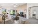 Open-concept living room offers neutral decor, access to the screened-in lanai, and views of the lake at 238 Acadia Dr, Poinciana, FL 34759