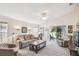 Inviting living room featuring vaulted ceiling, neutral decor, and sliding glass doors to the screened-in lanai at 238 Acadia Dr, Poinciana, FL 34759
