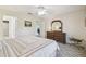 View of the main bedroom with en suite bathroom, closet, and a king bed facing dresser and mirror at 238 Acadia Dr, Poinciana, FL 34759