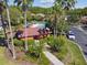 Aerial view of the community pool house featuring lush landscaping and parking at 238 Acadia Dr, Poinciana, FL 34759