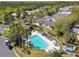 Aerial view of community pool surrounded by lush landscaping, lounge chairs, and neighborhood homes at 238 Acadia Dr, Poinciana, FL 34759