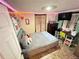 View of a bedroom featuring a gray bed, TV, desk, dresser, and decorations at 2406 Thelma Ave, Haines City, FL 33844