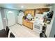 The kitchen features classic wood cabinets, white appliances, and a white tiled floor at 2406 Thelma Ave, Haines City, FL 33844