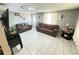 Living room with two couches, white tile floor, decorative tables, and a door to the outside at 2406 Thelma Ave, Haines City, FL 33844