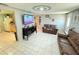 Open-concept living room flowing into kitchen, complete with tile floors and decorative art at 2406 Thelma Ave, Haines City, FL 33844