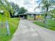 Quaint home with a fenced yard and ample parking in the long driveway at 2406 Thelma Ave, Haines City, FL 33844