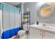 Bathroom featuring a sink, toilet, and decorative blue shower curtain at 2432 Olive Branch Way, Orlando, FL 32817