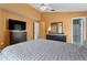 Bedroom with fan, walk-in closet, dresser, television, and ensuite bathroom at 2432 Olive Branch Way, Orlando, FL 32817