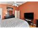 Comfortable bedroom with ceiling fan, dresser, television, and modern furnishings at 2432 Olive Branch Way, Orlando, FL 32817