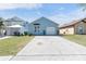 Charming single-story home featuring a concrete driveway and well-maintained lawn at 2432 Olive Branch Way, Orlando, FL 32817