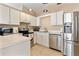 Well-equipped kitchen with stainless steel appliances, white cabinets, and tile flooring at 2432 Olive Branch Way, Orlando, FL 32817