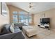 Bright living room with vaulted ceiling, large windows, tile floors, and comfortable seating at 2432 Olive Branch Way, Orlando, FL 32817