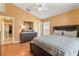 Comfortable bedroom with wood floors, a cozy bed, and ample natural light at 2432 Olive Branch Way, Orlando, FL 32817