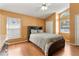 Inviting bedroom with hardwood floors, a ceiling fan, closet and a large window at 2432 Olive Branch Way, Orlando, FL 32817