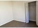 Bright bedroom with closet, neutral walls, light and modern wood-look flooring at 2520 Azzurra Ln, Ocoee, FL 34761