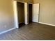Bedroom featuring wood-look flooring, neutral walls, and closet with bifold door at 2520 Azzurra Ln, Ocoee, FL 34761