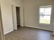 Cozy bedroom with wood-look floors, closet, and natural light from the window at 2520 Azzurra Ln, Ocoee, FL 34761