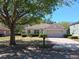 Charming single-story home featuring a well-maintained lawn, and a two-car garage, surrounded by green trees at 2520 Azzurra Ln, Ocoee, FL 34761