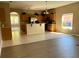 Open-concept layout featuring a kitchen with tiled floors and wood cabinets seamlessly flowing into the living area at 2520 Azzurra Ln, Ocoee, FL 34761