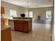Well-lit kitchen with a double sink and views of the living area and backyard through large windows at 2520 Azzurra Ln, Ocoee, FL 34761