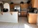 Bright kitchen features wooden cabinets, stainless steel refrigerator, and breakfast bar seating at 2520 Azzurra Ln, Ocoee, FL 34761