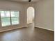 The living room offers wood-look floors and large windows, filling the space with natural light at 2520 Azzurra Ln, Ocoee, FL 34761