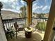 Relaxing balcony features comfortable seating and a pleasant view of the surrounding neighborhood and sky at 2787 Oakwater Dr, Kissimmee, FL 34747